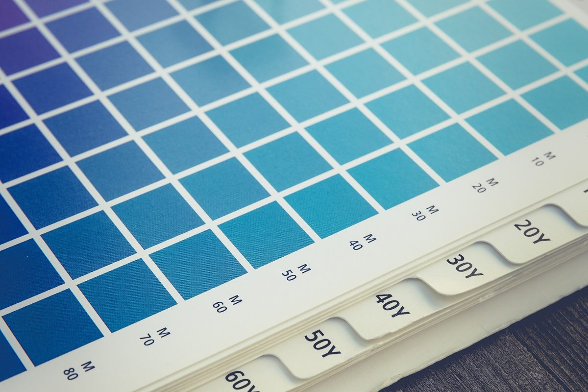 Pantone-style color swatch book with a loupe for color matching